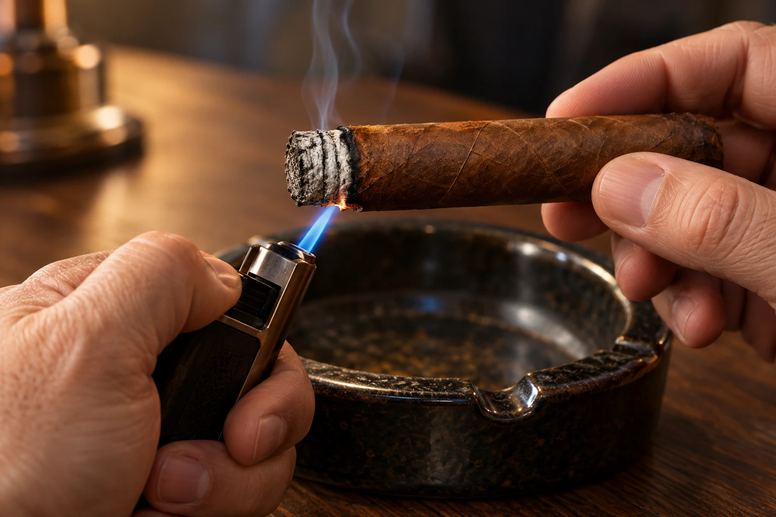 Adult hands using a small blue lighter flame at the uneven burn line of a partly smoked cigar above an ashtray